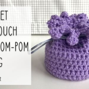 crochet mini pouch with pom-pom edging